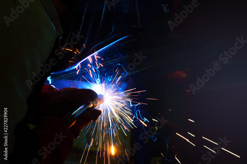 sparks during welding at the production process in semi-automatic welding of metal in argon protective gases