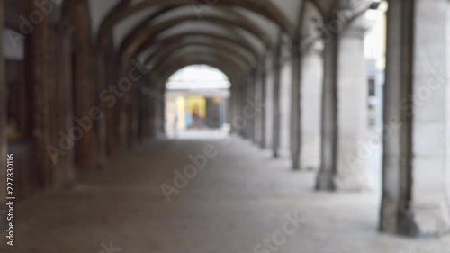 Out of focus background plate of colonnade in front of building with arches