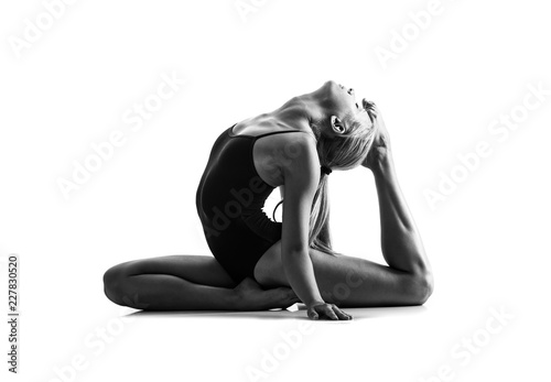 Young blonde woman in maillot practicing yoga lesson