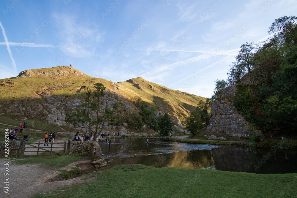 Tourists enjoying the view and hike at Dovedale Stepping stones, Ilam, Ashbourne, Derbyshire, UK, August 2018