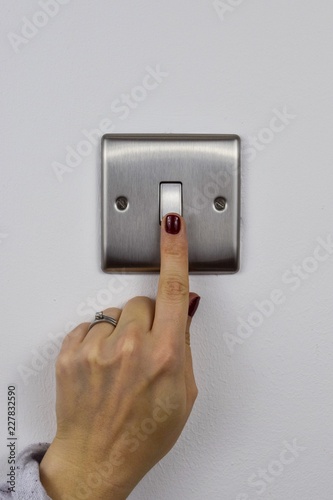 Obraz na płótnie Finger on a light switch w salonie
