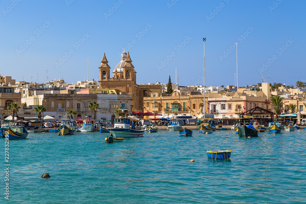 Marsaxlokk, Malta. Scenic view of the city and the cathedral from the bay