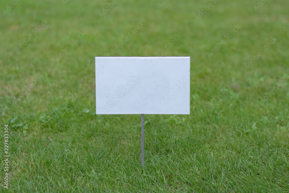 Empty white sign on the lawn