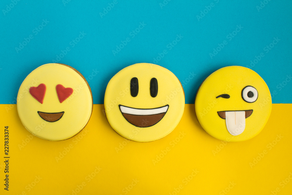 Smileys in the form of gingerbread on the colorful background.Top view.Closeup.Copy space. Smileys in the form of gingerbread on the colorful background.Top view.Closeup.Copy space.