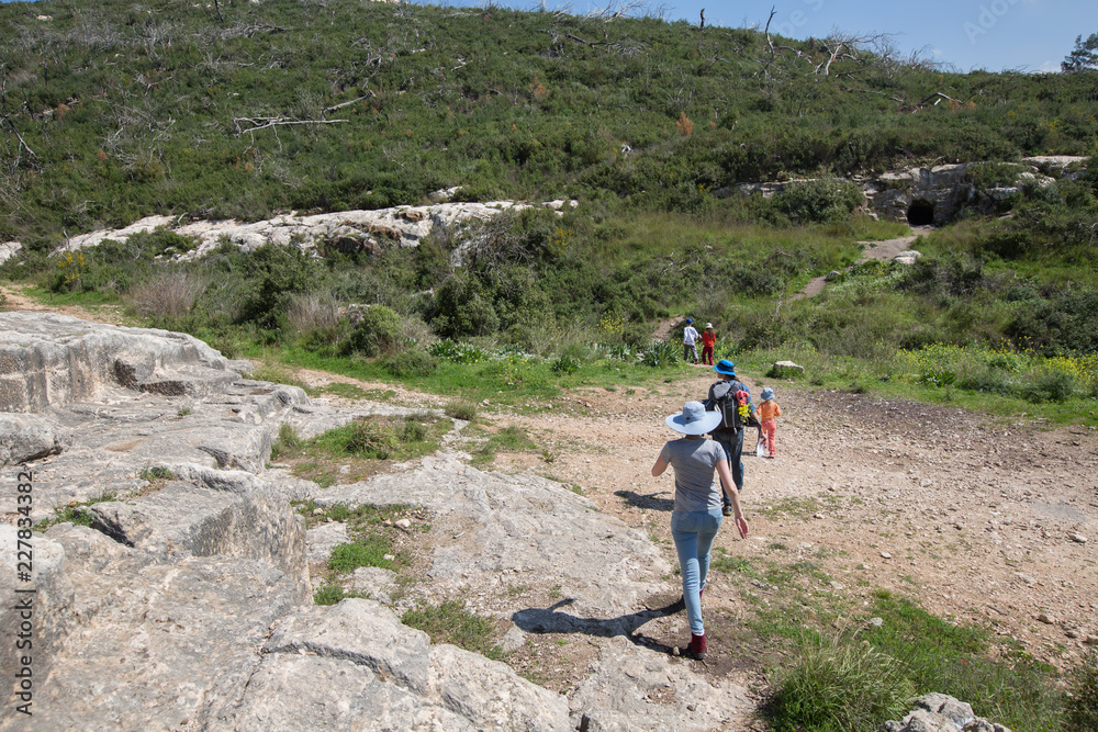 Young family hike along an  abandoned stone quarry on Carmel mount in Haifa, Israel