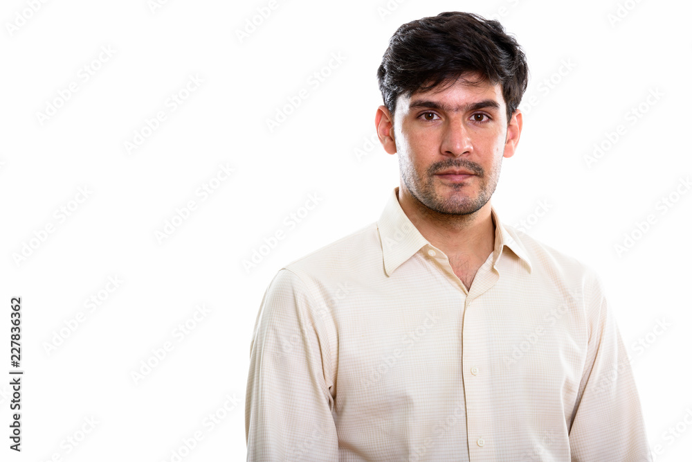 Studio shot of young handsome Persian businessman Studio shot of young handsome Persian businessman