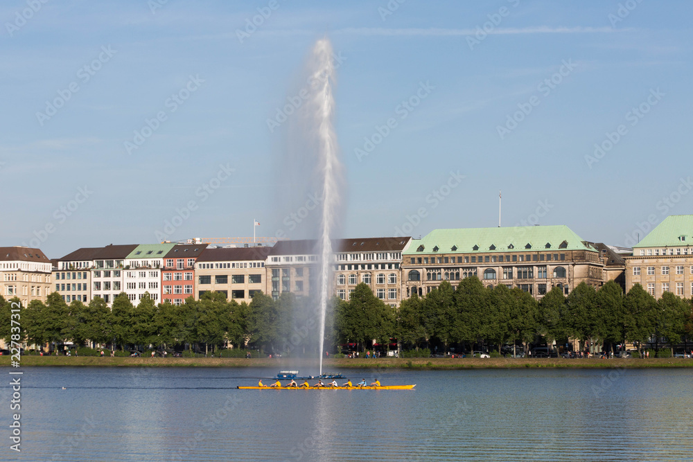 Fototapeta premium View of Alster lake, Hamburg, Germany, Fountain with a rainbow