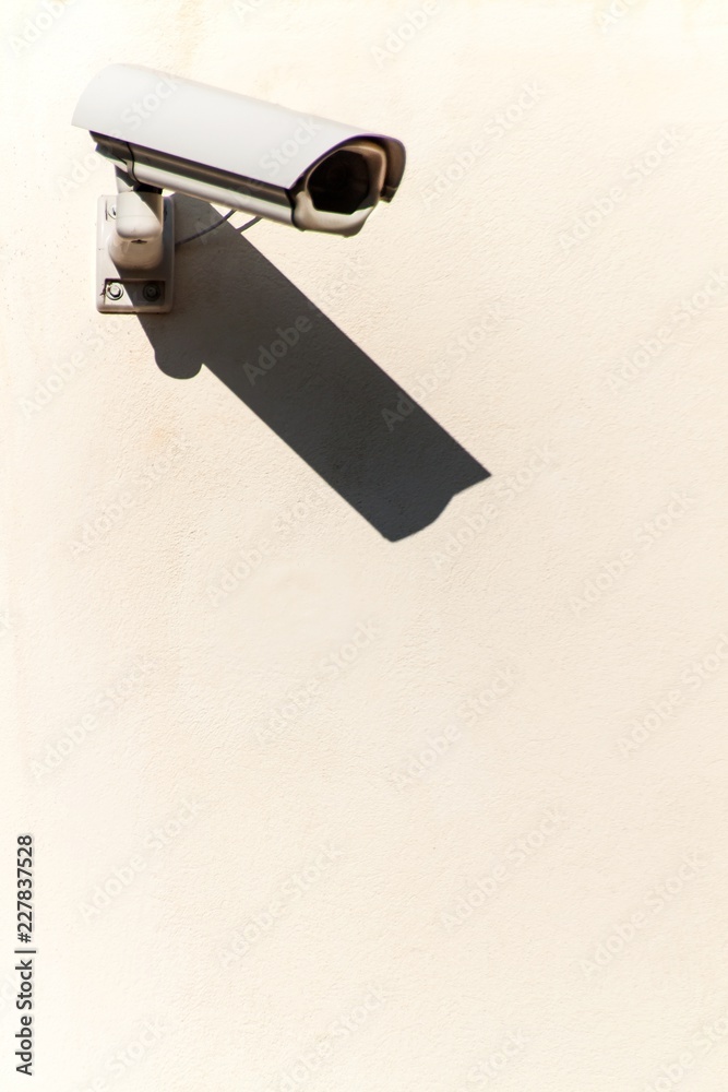 Security camera on the wall. Place for text. Big Brother. Property protection. Security camera on the wall. Place for text. Big Brother. Property protection.
