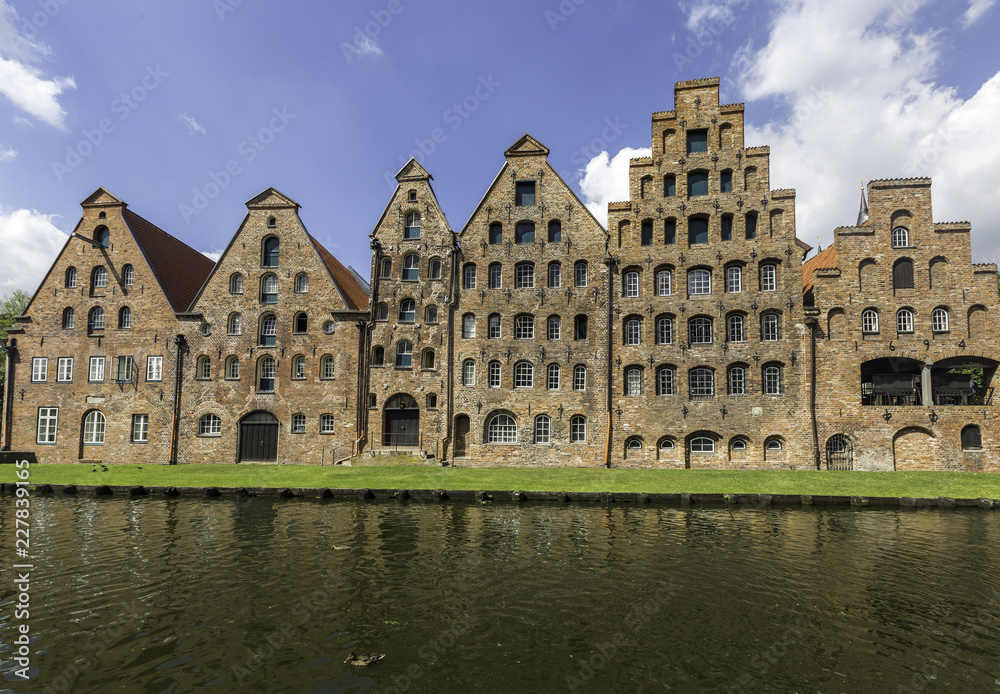 Facade of old buildings near the river, in Lubeck, Germany