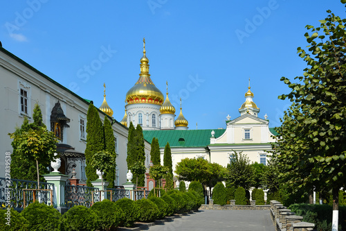 Religious buildings, Orthodox Christian cathedral with golden domes. Huge religious complex. Holy Dormition Pochayiv Lavra in Ukraine.