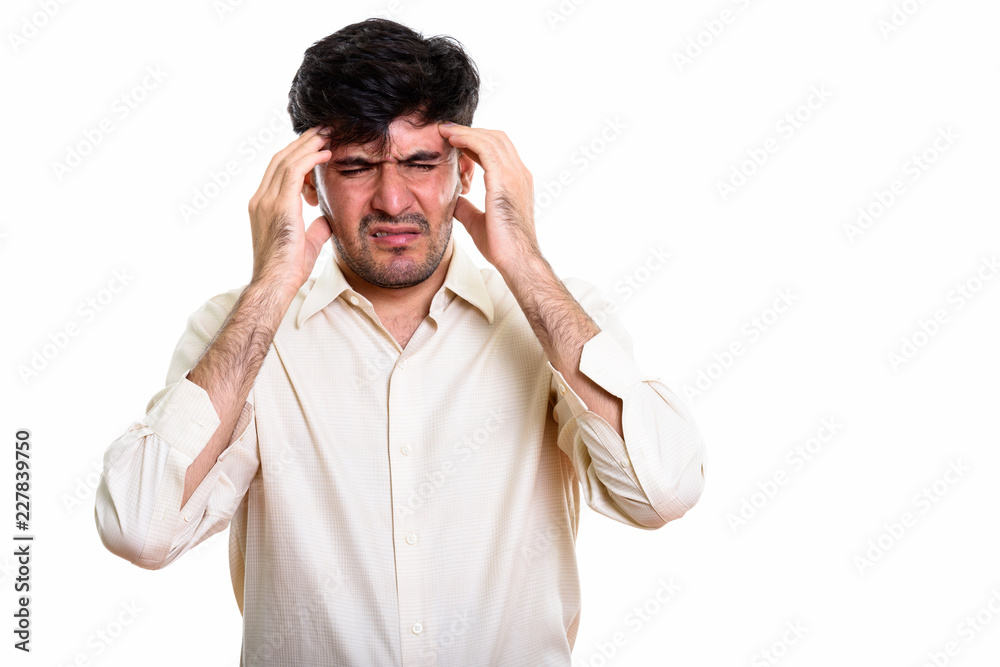 Naklejka premium Studio shot of stressed Persian businessman having headache