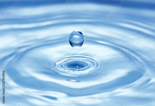 pure blue water surface with droplet splash