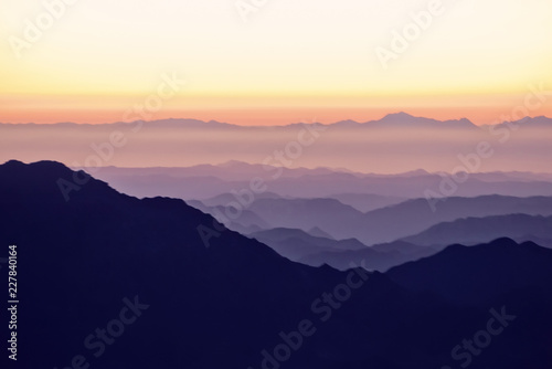 Silhouette of mountains at sunset in the evening at dusk Mount Moses Sinai Egypt Landscape with aerial perspective, air fog © IRINA