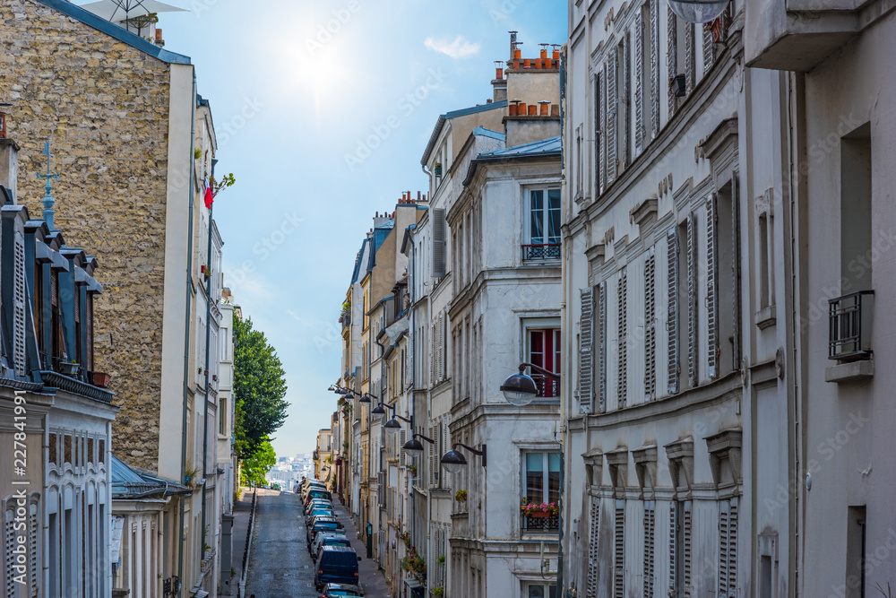 Sun shining over a narrow street in Paris