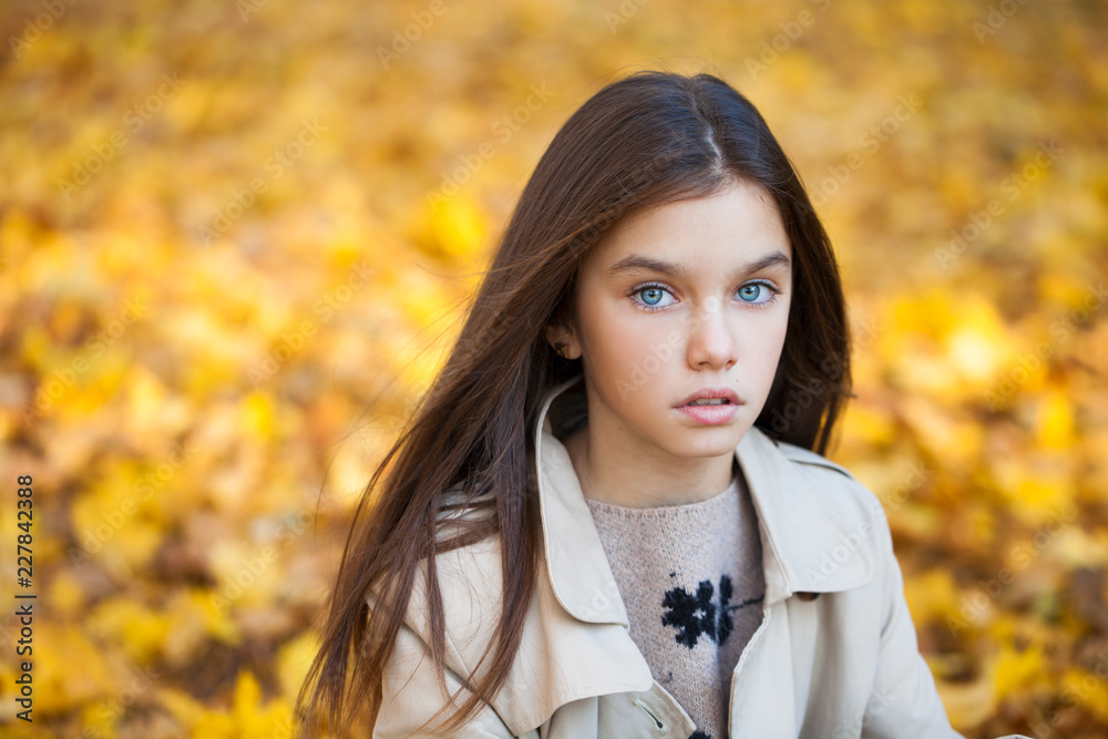 Happy young little girl in beige coat Happy young little girl in beige coat