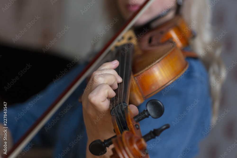 Girl playing the violin. Hand of a girl and a fiddle. Girl playing the violin. Hand of a girl and a fiddle.