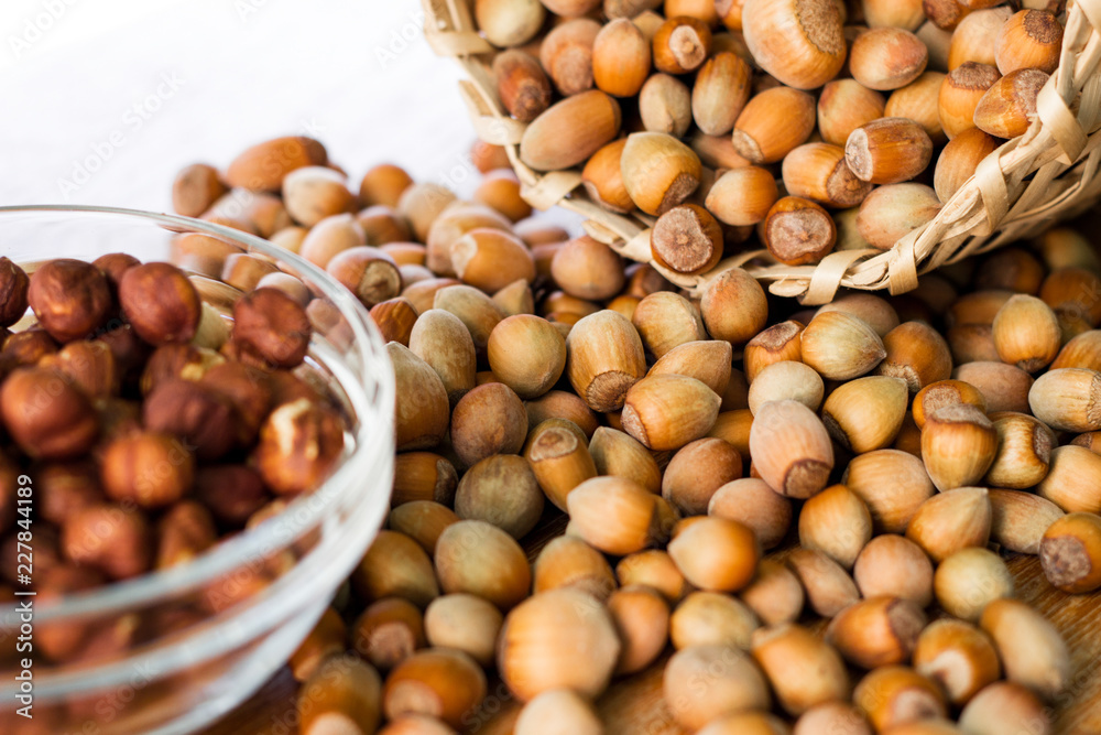 Hazelnuts in a wicker basket on old wooden table Hazelnuts in a wicker basket on old wooden table