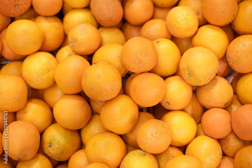 Fresh oranges in a supermarket. box of ripe oranges. background of orange fruit. fruit shop. bright juicy color