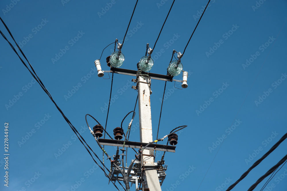 pole with electrical and telephone wires against the blue sky. internet cable light guide. electricity on a concrete pole pole with electrical and telephone wires against the blue sky. internet cable light guide. electricity on a concrete pole