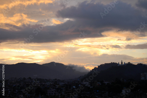 The romantic sunset view of Swayambhunath Stupa from the rooftop in Kathmandu
