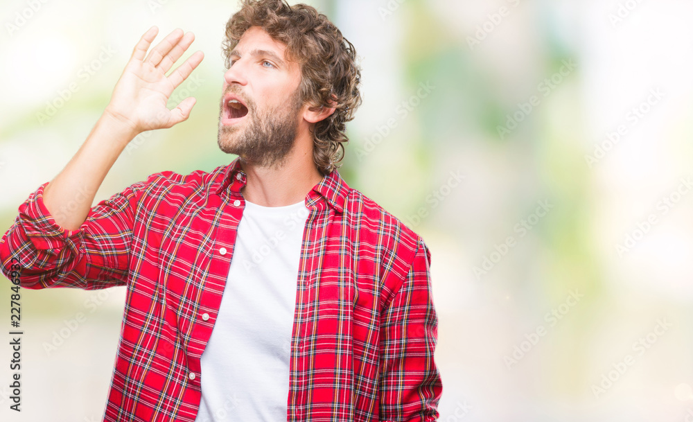 Handsome hispanic model man over isolated background shouting and screaming loud to side with hand on mouth. Communication concept. Handsome hispanic model man over isolated background shouting and screaming loud to side with hand on mouth. Communication concept.