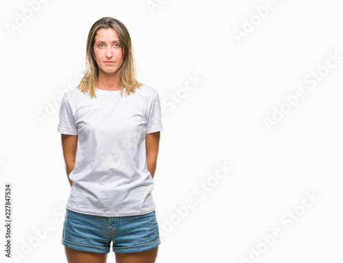 Young beautiful woman over isolated background with serious expression on face. Simple and natural looking at the camera.