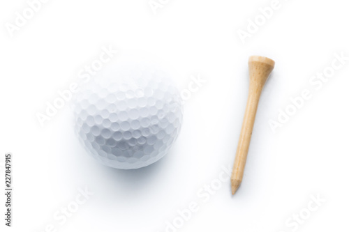 Golf ball and wooden tee on a white background