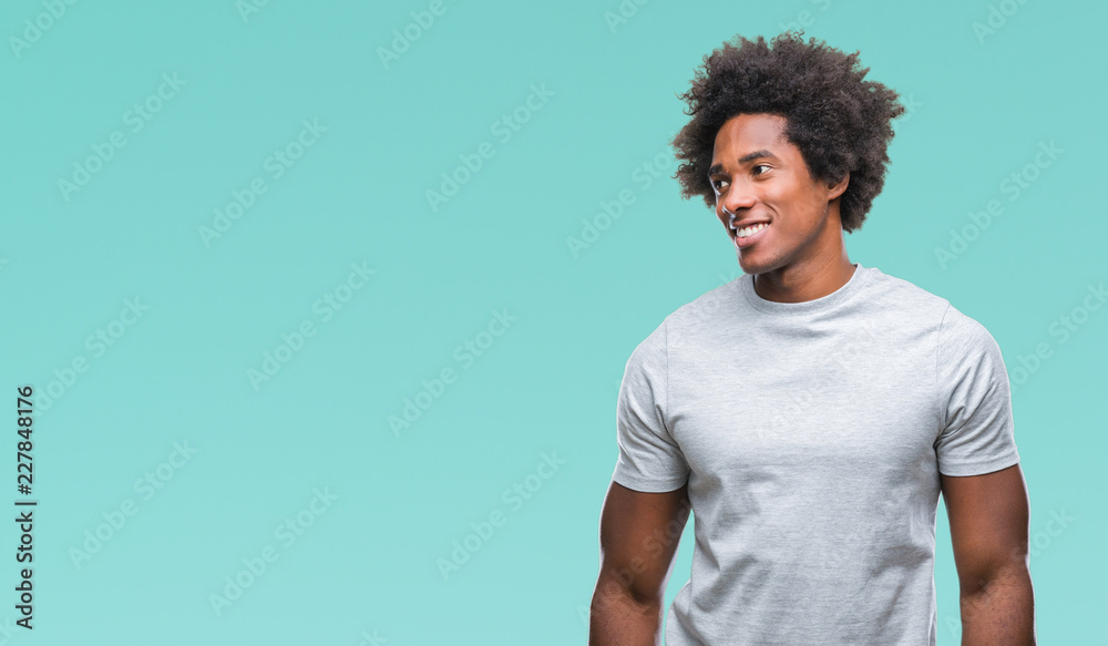 Afro american man over isolated background looking away to side with smile on face, natural expression. Laughing confident. Afro american man over isolated background looking away to side with smile on face, natural expression. Laughing confident.