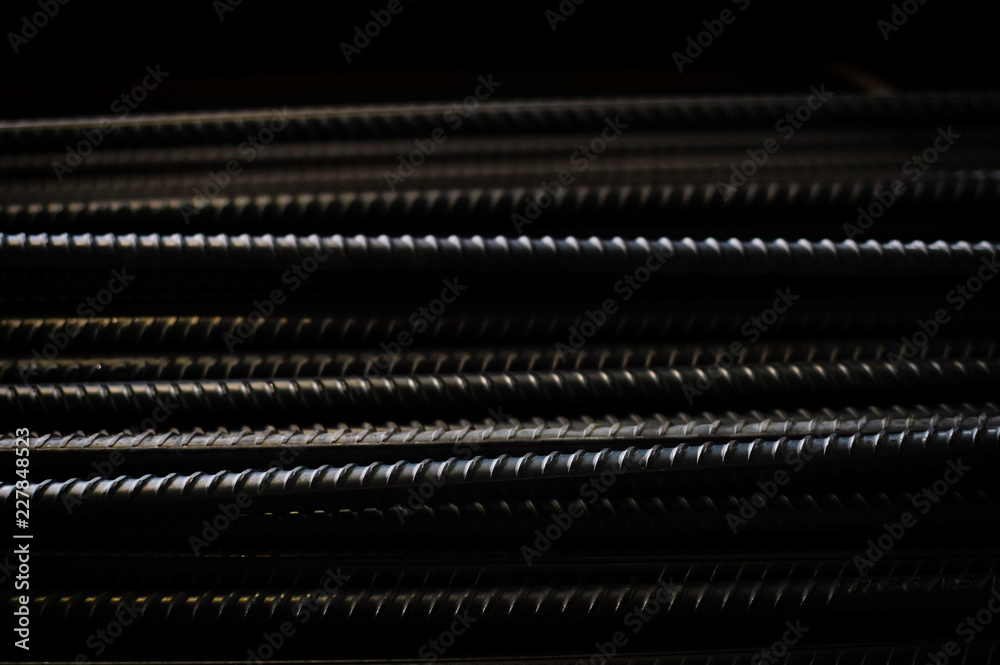 closeup of hard rods division rebars, used on stacked construction concrete background. industrial professional equipment pattern, stiff macro perspective image for reinforcement and construction. closeup of hard rods division rebars, used on stacked construction concrete background. industrial professional equipment pattern, stiff macro perspective image for reinforcement and construction.