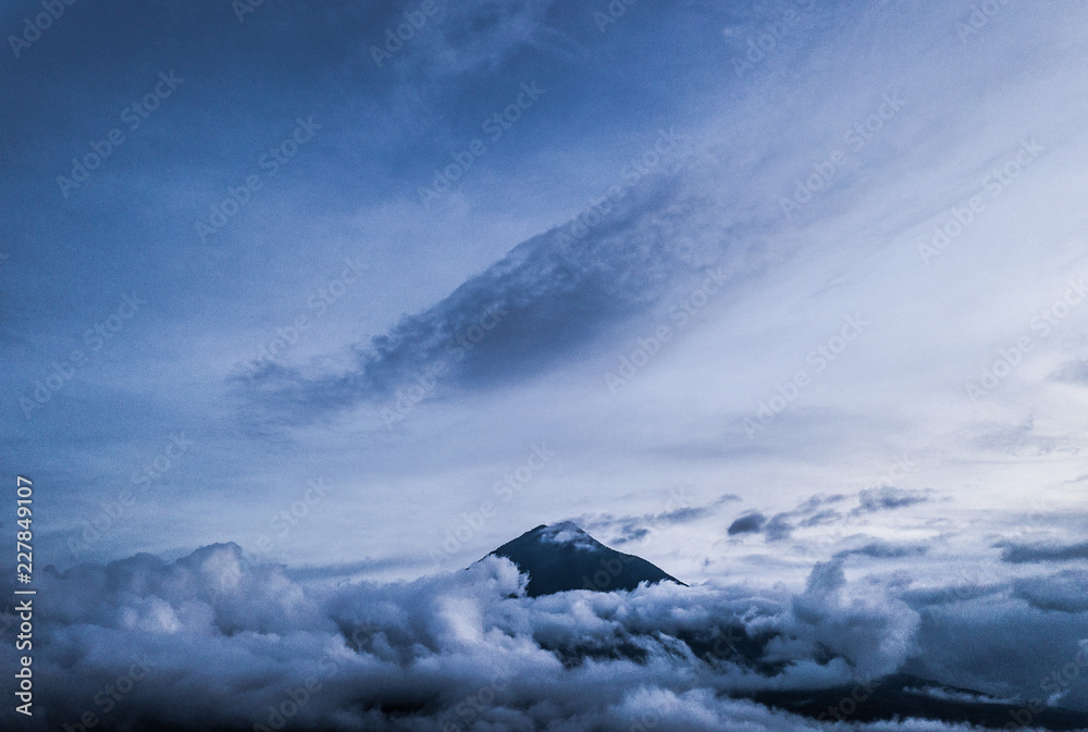 Aerial of Agua volcano near Antigua, Guatemala among clouds