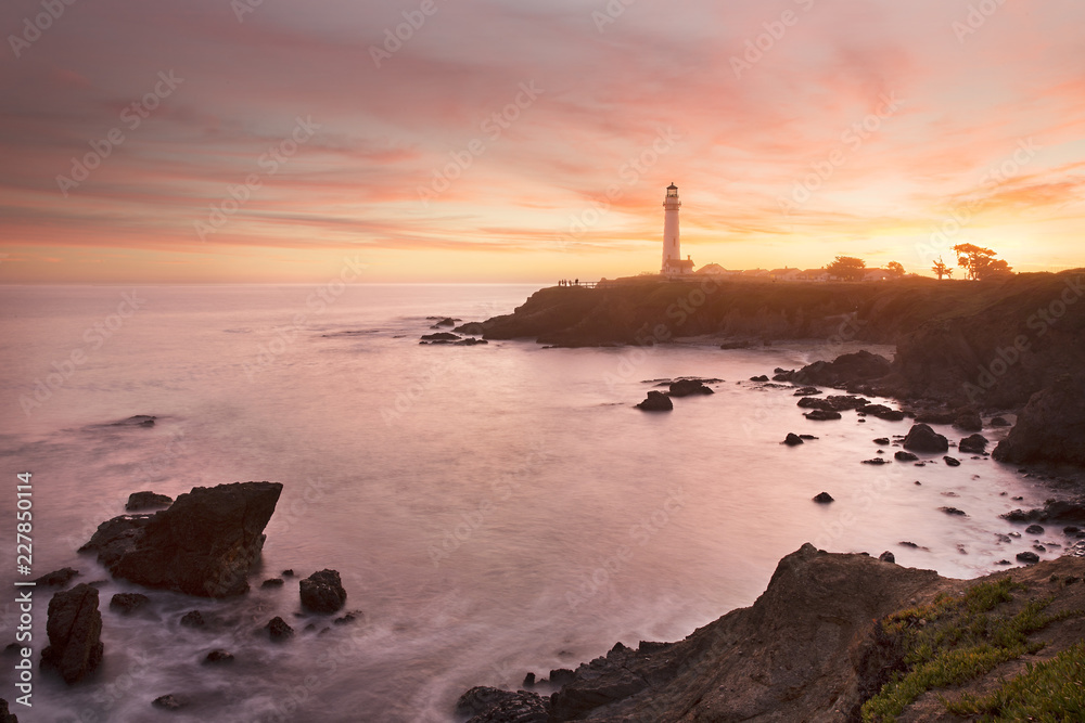 Pigeon Point lighthouse set against the setting sun