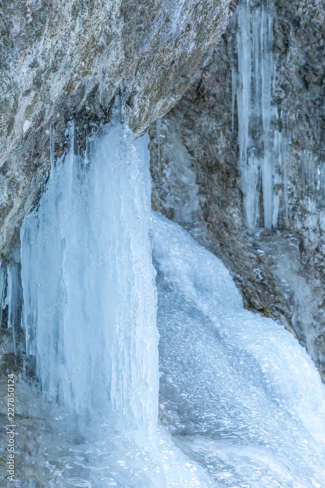 Detail of a winter landscape, icefall on a rock wall. Detail of a winter landscape, icefall on a rock wall.