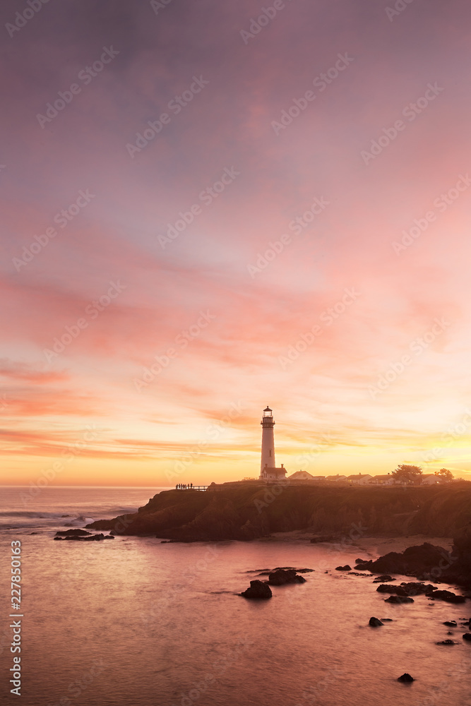 Pigeon Point lighthouse set against the setting sun