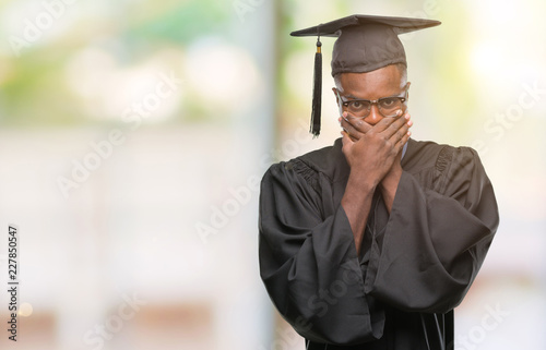 Young graduated african american man over isolated background shocked covering mouth with hands for mistake. Secret concept.