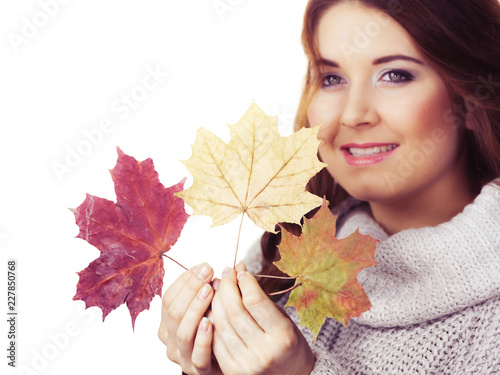 Smiling woman holding colorful maple leaves