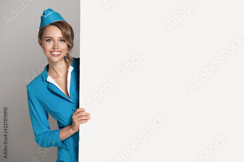 Portrait of charming stewardess wearing in blue uniform. Empty blank copyspace. photo