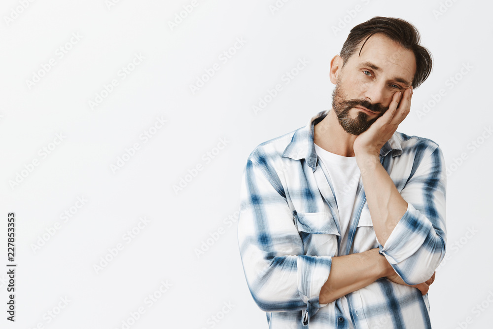 So boring. Indifferent cute adult man with beard and dark hair, leaning face on palm and gazing with careless tired expression at camera, fed up of listening meeting for hours, bored and exhausted So boring. Indifferent cute adult man with beard and dark hair, leaning face on palm and gazing with careless tired expression at camera, fed up of listening meeting for hours, bored and exhausted