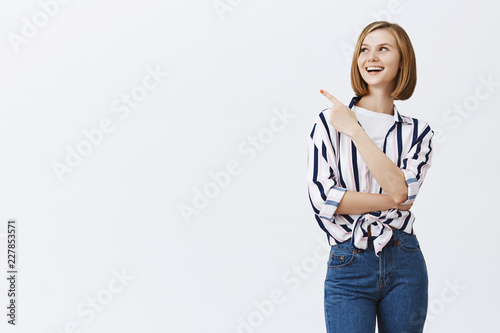 Фотография Portrait of charming happy caucasian girl with short fair hait being amused and