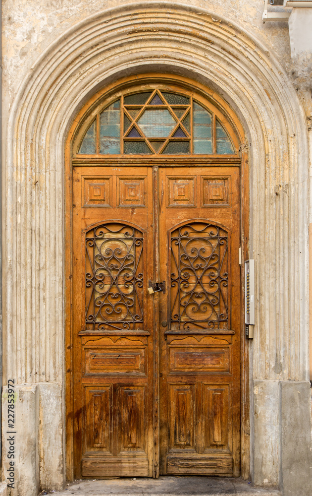 Old carved wooden door, with Magen David icon on top