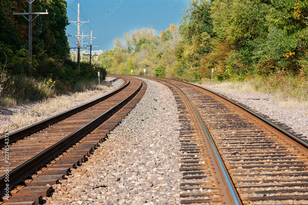 View of double steel railroad tracks on a sunny day