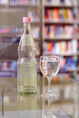 Glass and bottle of water closeup photo