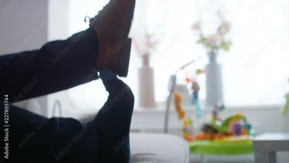 Feet of a man kicking his shoes off to relax, in slow motion Feet of a man kicking his shoes off to relax, in slow motion