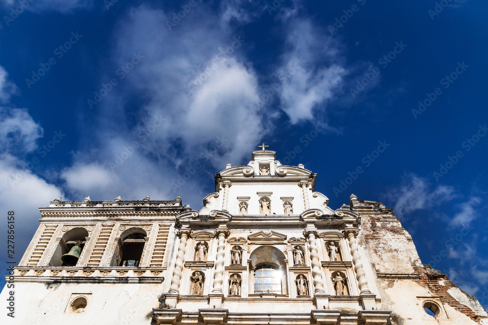 Templo de San Francisco el Grande from low angle view with blue sky and clouds in Antigua, Guateamala, Central America