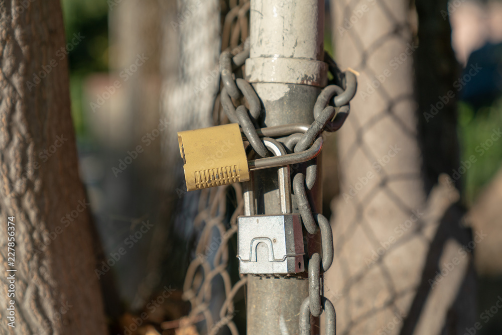 Close up of padlock and chain on fence Close up of padlock and chain on fence