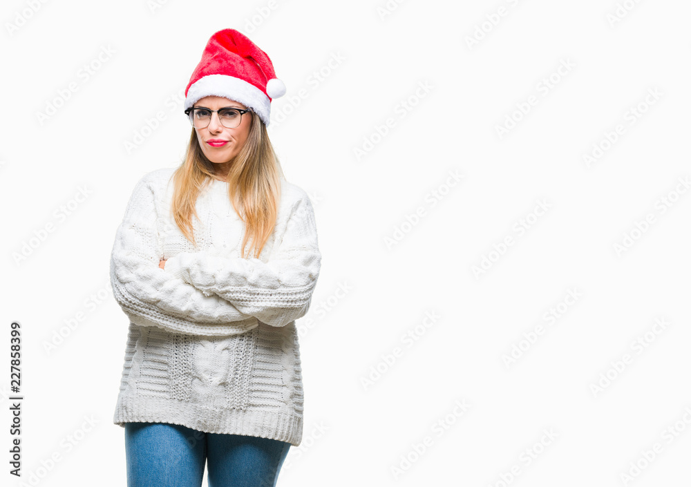 Young beautiful woman wearing christmas hat over isolated background skeptic and nervous, disapproving expression on face with crossed arms. Negative person. Young beautiful woman wearing christmas hat over isolated background skeptic and nervous, disapproving expression on face with crossed arms. Negative person.