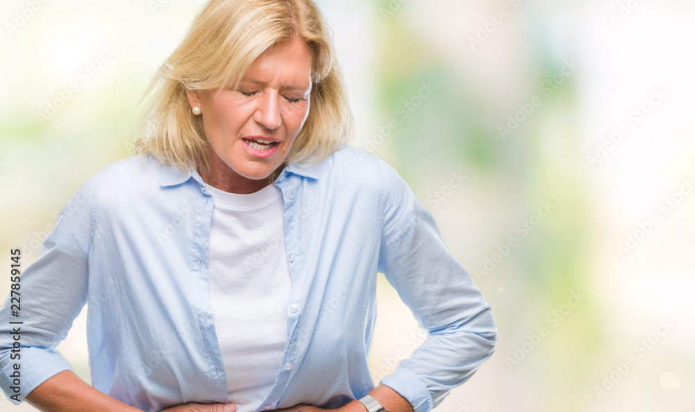 Obraz premium Middle age blonde woman over isolated background with hand on stomach because indigestion, painful illness feeling unwell. Ache concept.