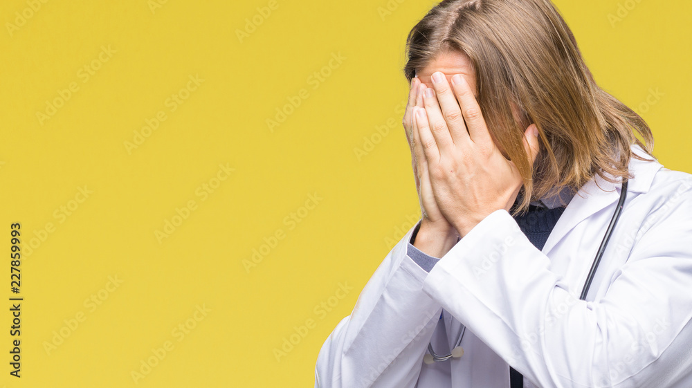 Young handsome doctor man with long hair over isolated background with sad expression covering face with hands while crying. Depression concept. Young handsome doctor man with long hair over isolated background with sad expression covering face with hands while crying. Depression concept.