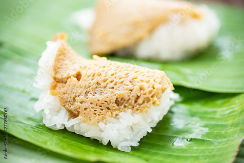 Thai dessert (Khao Niao Sangkhaya), Sweet sticky rice with egg custard on top and wrapping with fresh banana leaf photo