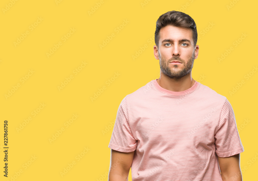 Young handsome man over isolated background with serious expression on face. Simple and natural looking at the camera. Young handsome man over isolated background with serious expression on face. Simple and natural looking at the camera.