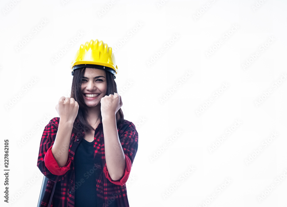 The young woman engineer wear yellow safety helmet ,raise hands up,excited cheerful with joyful expression,sign of success in deal The young woman engineer wear yellow safety helmet ,raise hands up,excited cheerful with joyful expression,sign of success in deal